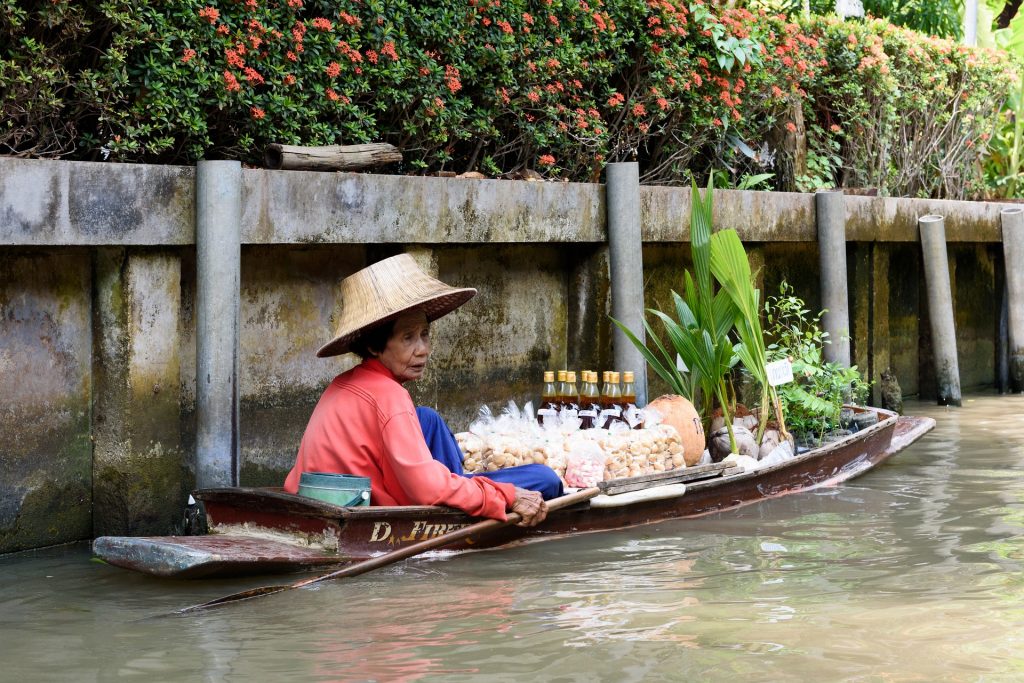 Vendor on the floating market in Thailand.