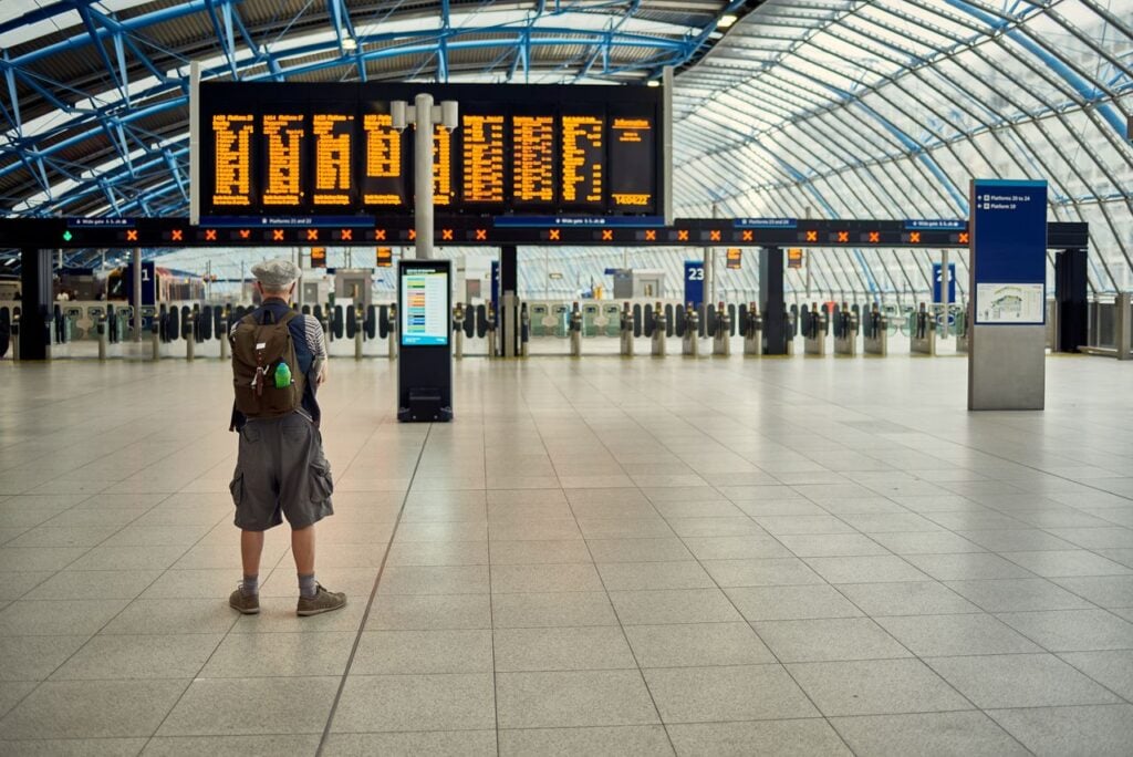 Traveler checking an airport departure board Traveler checking an airport departure board