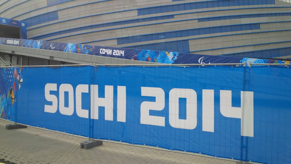 Blue Sochi 2014 signage displaying the Paralympic symbol outside a sporting venue in Sochi, Russia. Photo taken by Ian Fitzpatrick