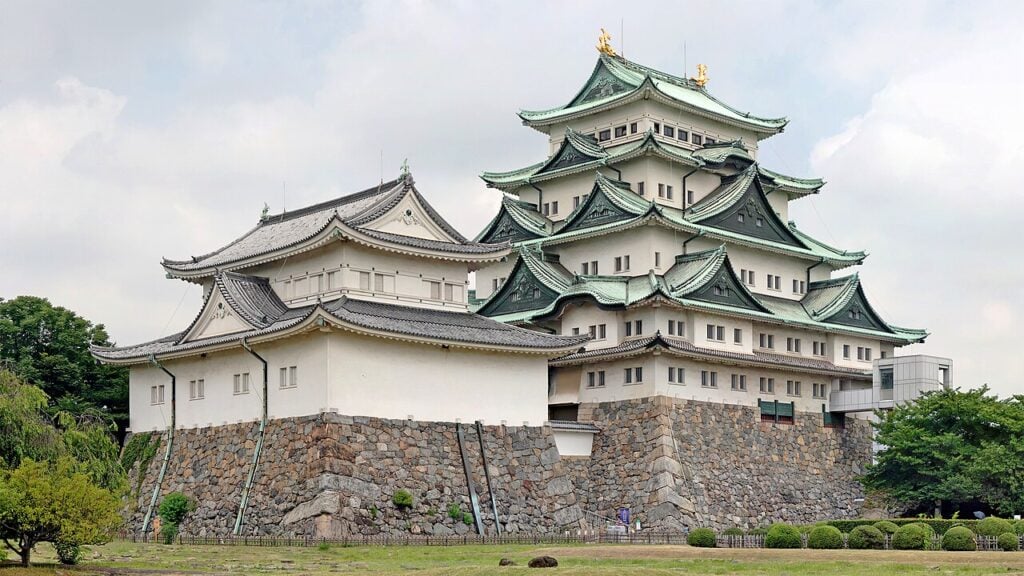 Nagoya Castle Reconstructed main keep of Nagoya Castle with green-tiled roofs above stone walls in Nagoya, Japan