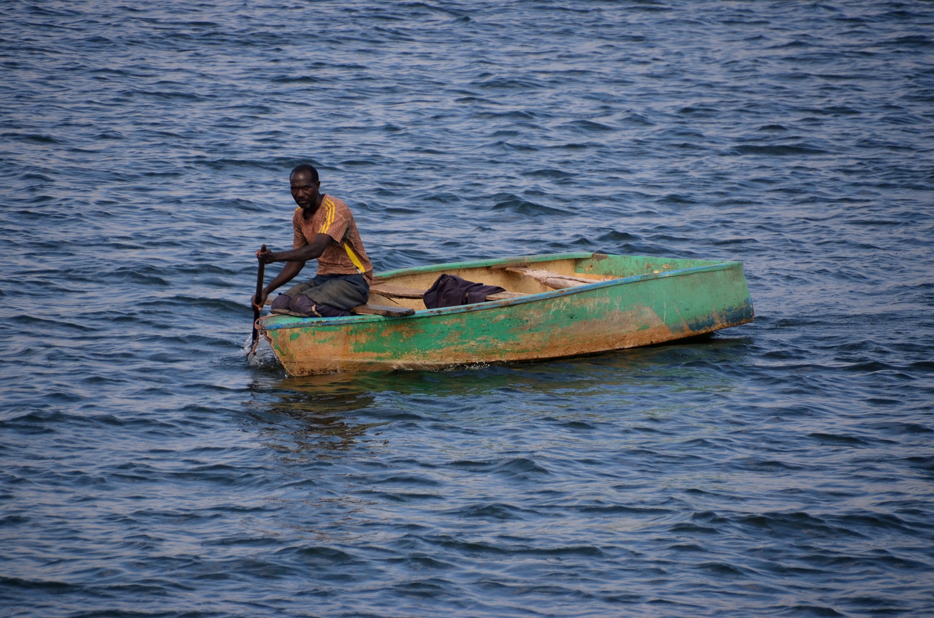 Man in a fishing boat on Lake Karibasee in Zimbabwe.