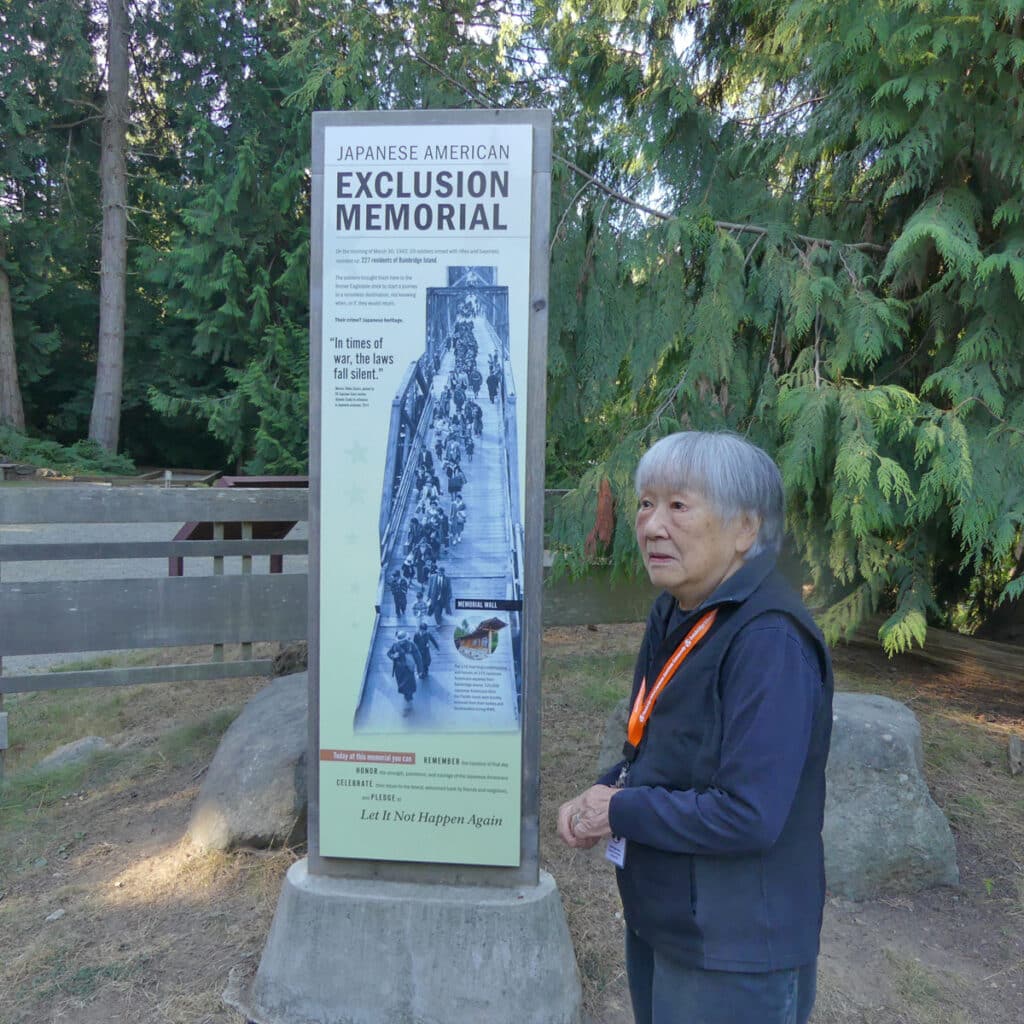 Lilly Kodoma, a Japanese American, stands at entrace of Japanese American Exclusion Memorial. Photo: Kathleen Walls