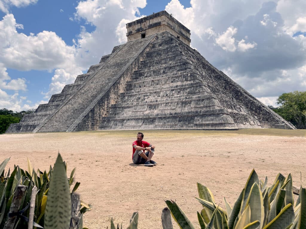 Author enjoying the peaceful sunlight in front of the Chichen Itza Pyramid