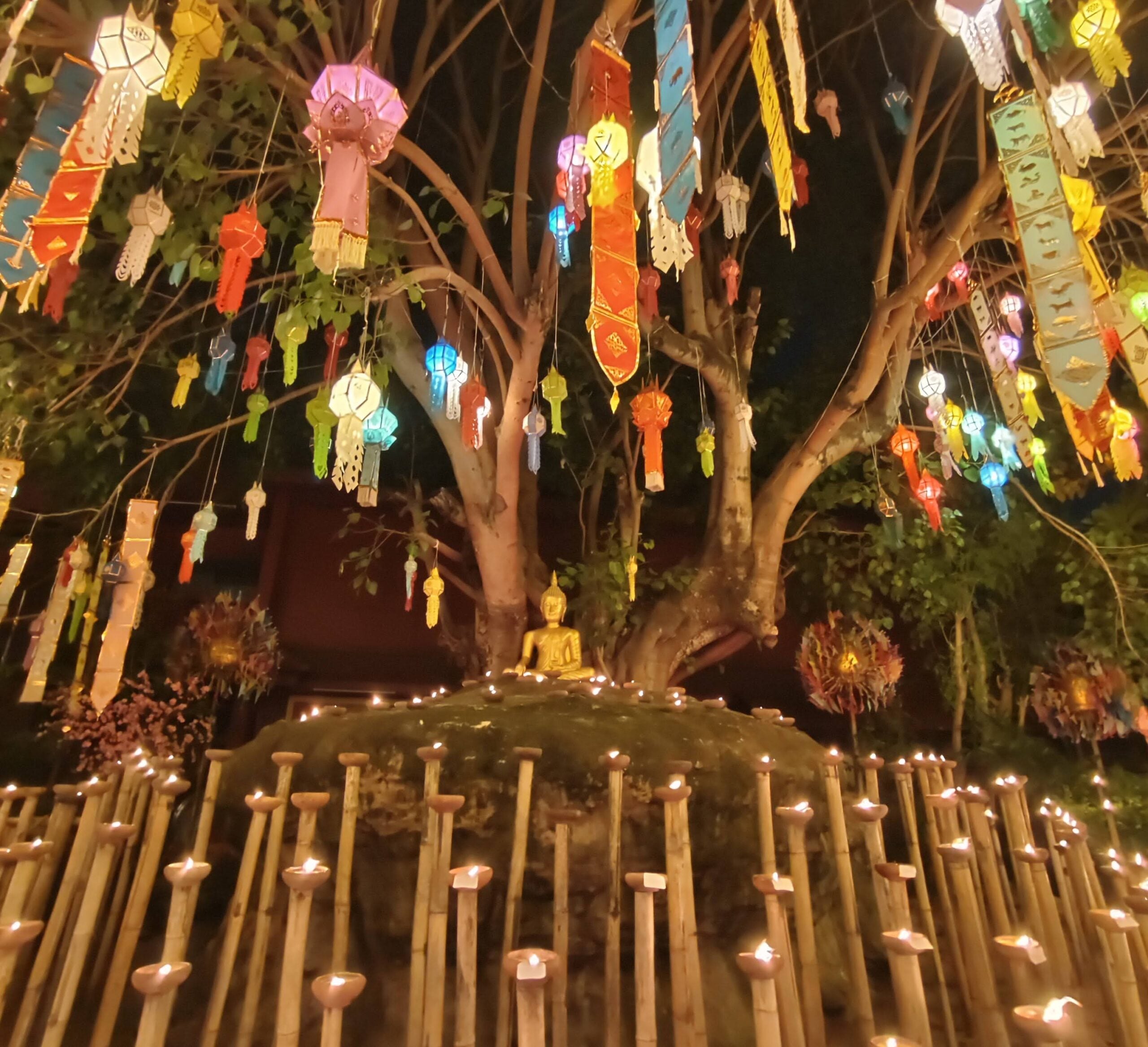 Chiang Mai Lanterns lit on bamboo poles surround the Buddha on New Year’s Eve. Photo Teh Chin Liang