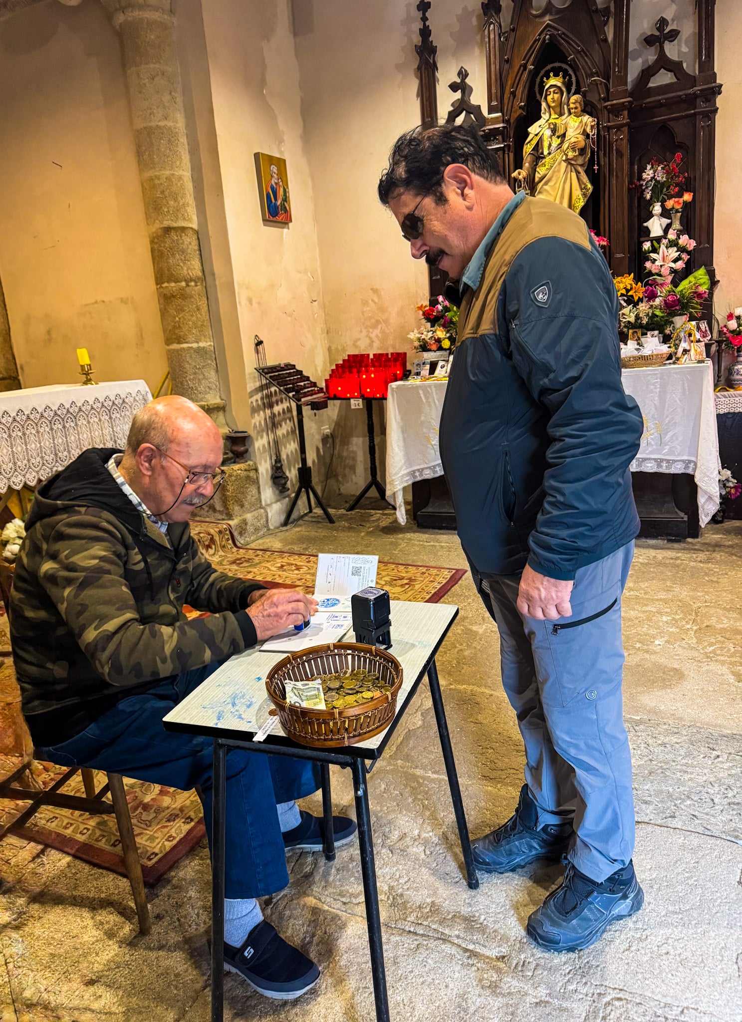 Camino Getting my Camino Pilgrim Passport stamped at a church in Palas de Rei Copy Camino de Santiago
