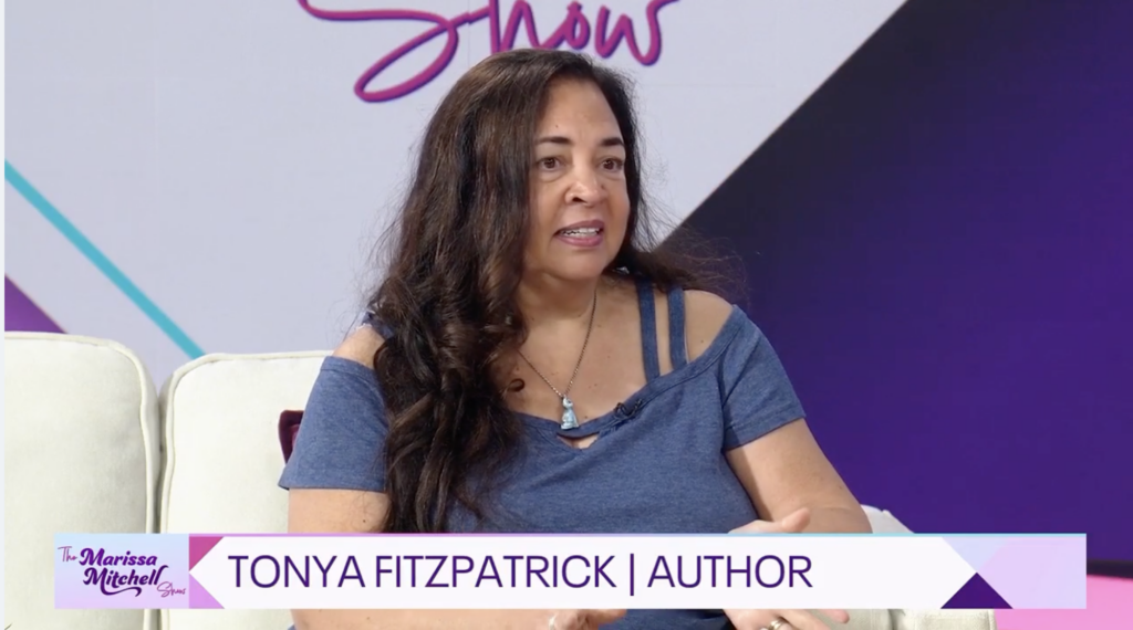 Tonya Fitzpatrick quthor image on MM Show Tonya Fitzpatrick in the studio of The Marissa Mitchell show. Banner reflects her as an author.