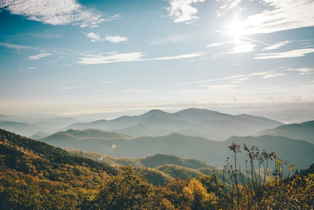 Photo by Wes Hicks North Carolina aerial photography of mountain under blue and white sky resembles a scene from The Hunger Games.