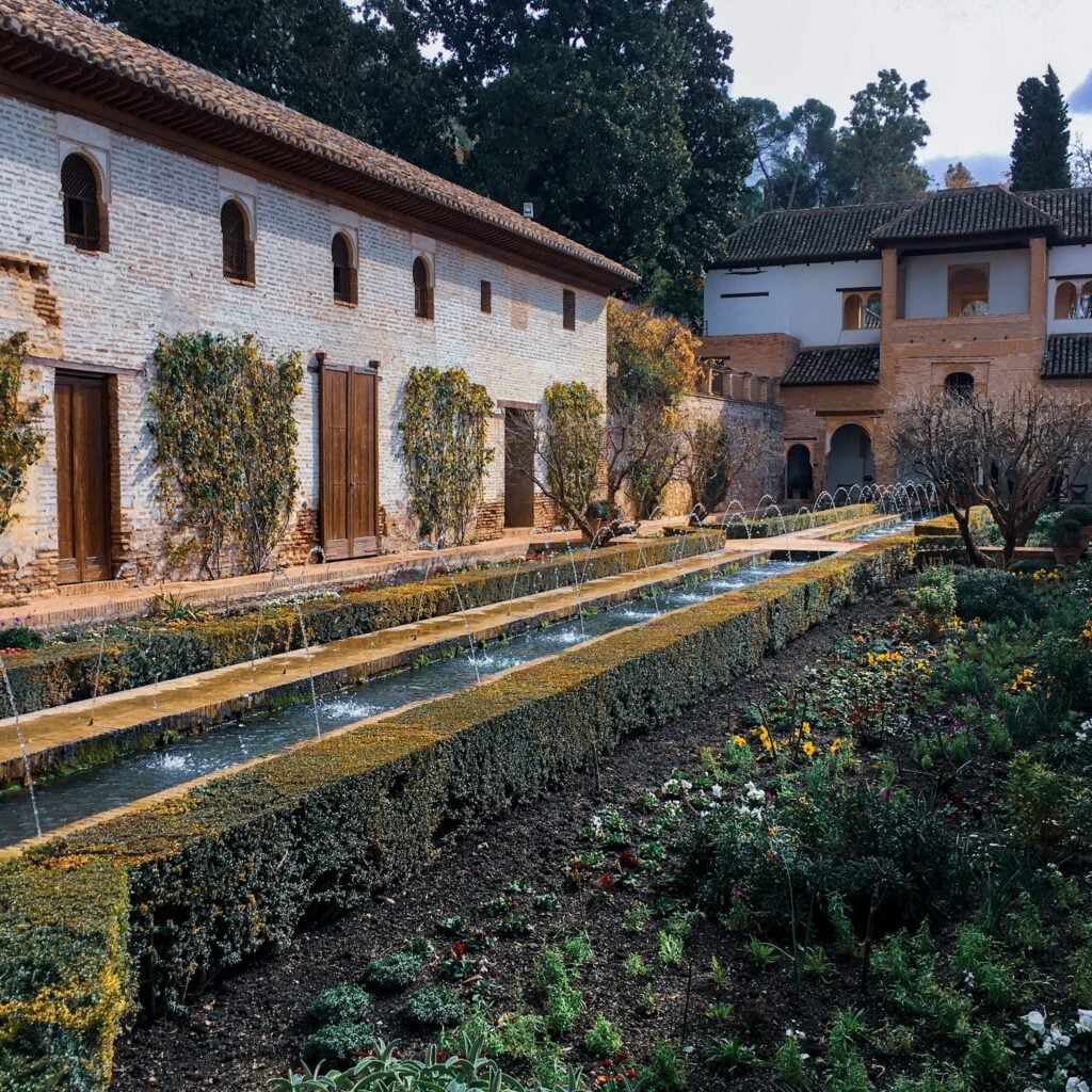 Terraced gardens and narrow water channels at the Generalife in Granada, Spain.