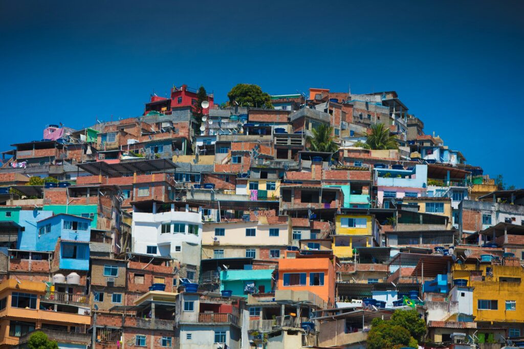 Photo by Wolf Schram Colorful homes rising across a densely built hillside favela in Rio de Janeiro