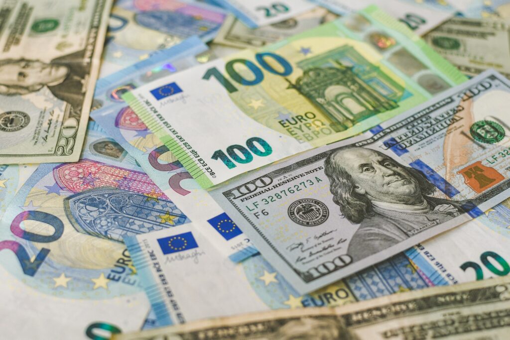 U.S. dollar bills and euro banknotes arranged together