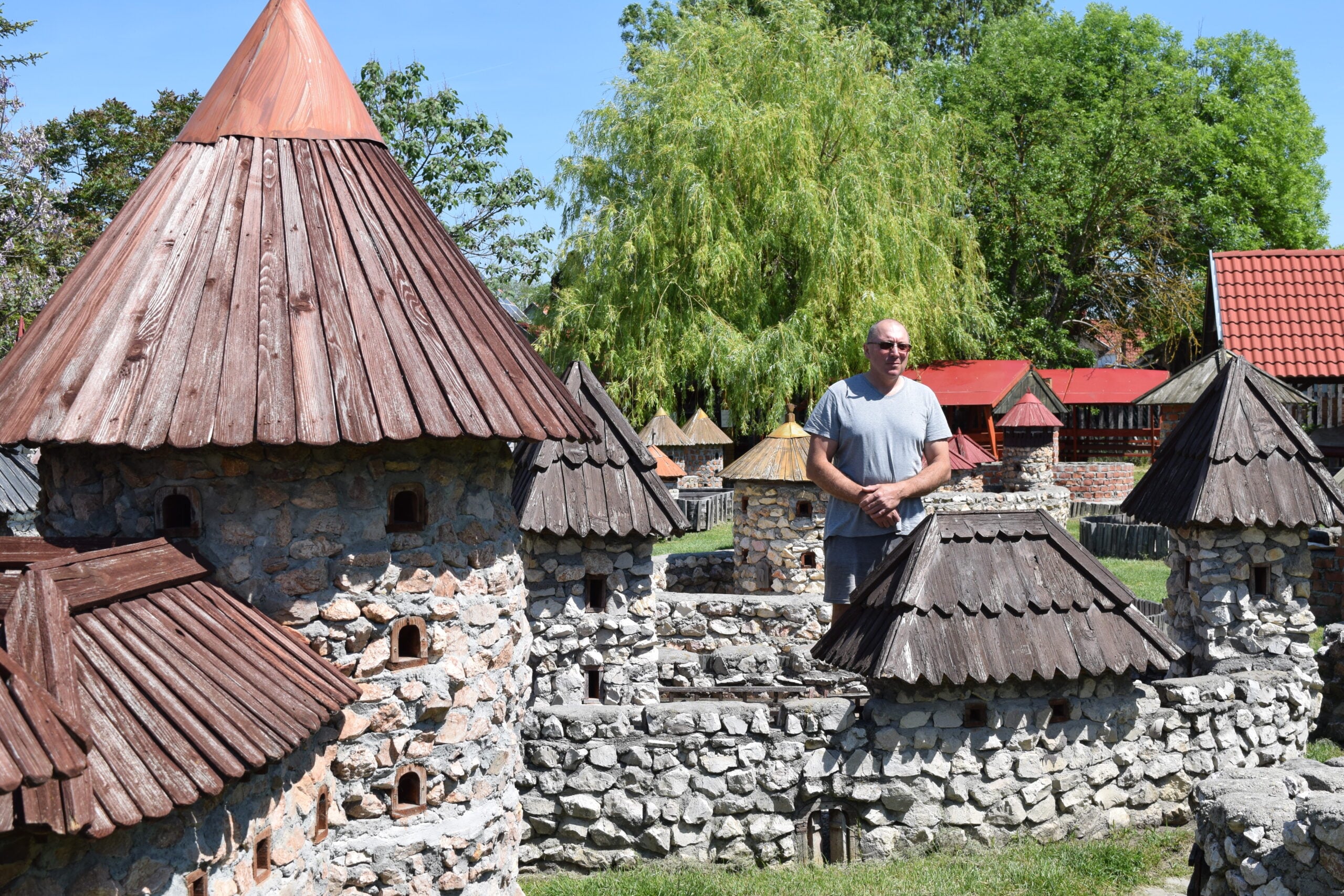 Man sittin among reconstructed Castles from the middle ages