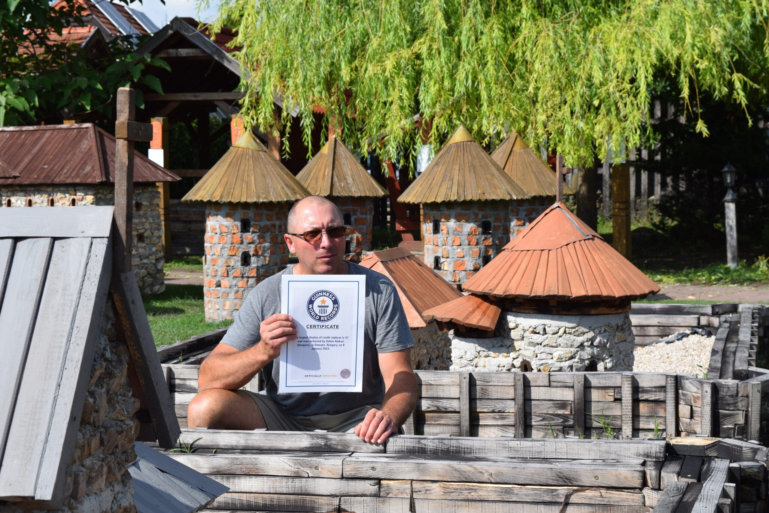 Hungarian Zoltán Alekszi with the Guinness World Records certificate for the largest display of castle replicas. 